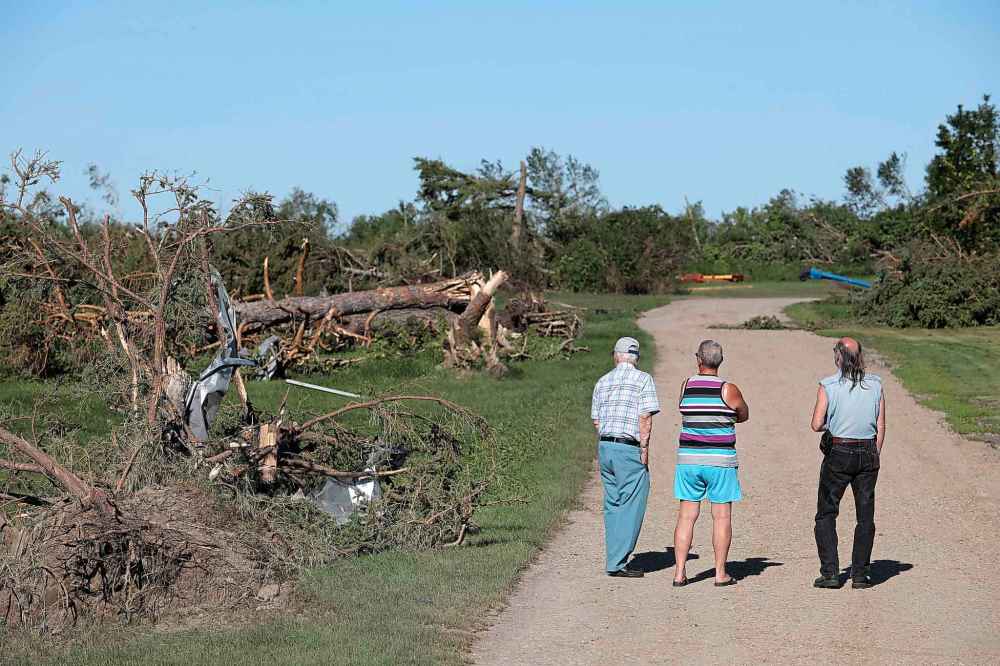 People survey the damage at Giovanni Colangelo's farm south of Virden on Saturday after a powerful tornado tore through the farm Friday evening. (Tim Smith/The Brandon Sun)