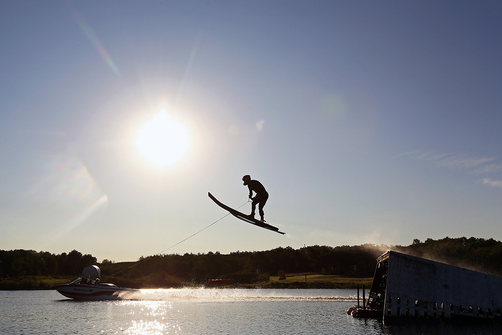 Professional water ski jumper Casey Mommer soars through the air over the water of Lake Wahtopanah on a calm and clear Tuesday morning. (Tim Smith/The Brandon Sun)