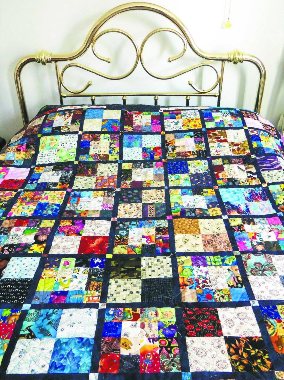 After making over 1,000 cloth face masks, Margaret James used the leftover fabric to make a colourful quilt. (Submitted)