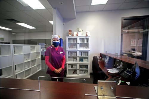 The Skin & Vein Centre in Brandon is taking several measures to keep patients and staff safe during the COVID-19 pandemic, including installing a plexiglass shield at their front desk.