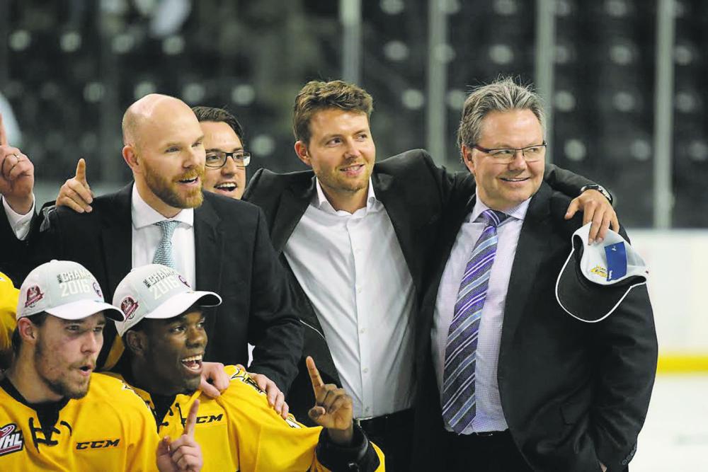 Kelly McCrimmon, right, celebrates the Brandon Wheat Kings capturing the Western Hockey League champion in May 2016 against the Seattle Thunderbirds in Kent, Wash. His son Mick stands in the middle, with former assistant coach and current general manager Darren Ritchie on the left. Former Wheat Kings employee Matt McNish can be seen in the background. (Perry Bergson/The Brandon Sun)