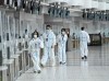 Workers are seen at a check-in counter at Pearson International Airport during the COVID-19 pandemic in Toronto on Wednesday, Oct. 14, 2020. Airlines say a slew of questions remain around the federal government's decision that requires returning passengers to first show negative results on COVID-19 tests taken abroad. THE CANADIAN PRESS/Nathan Denette