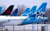 Air Transat and an Air Canada aircrafts are seen on the tarmac at Montreal-Trudeau International Airport in Montreal, on Wednesday, April 8, 2020. Transat AT has reconfirmed its unanimous support for its proposed acquisition by Air Canada while issuing a clarification about a proposal from telecom owner Pierre Karl Peladeau. THE CANADIAN PRESS/Paul Chiasson