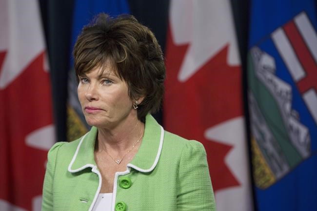 Minister of Energy Sonya Savage listens while Premier Jason Kenney responds to the media at a press conference in Edmonton on June 18, 2019. THE CANADIAN PRESS/Amber Bracken