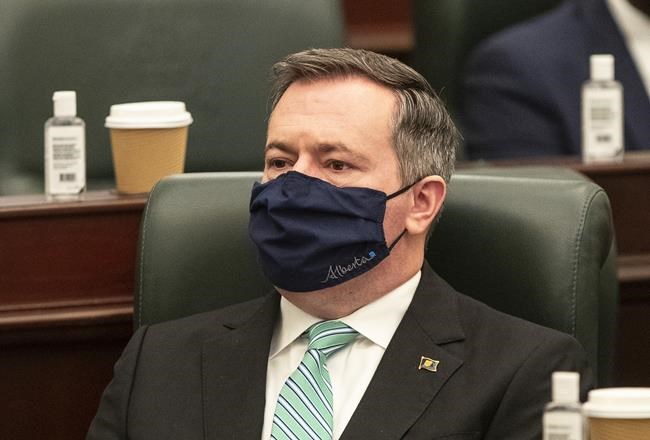 Alberta Premier Jason Kenney listens as the 2021 budget is delivered in Edmonton on Thursday Feb. 25, 2021. Kenney says the province will stay the course on its current COVID-19 heath restrictions despite rising case numbers and more variants of concern. THE CANADIAN PRESS/Jason Franson
