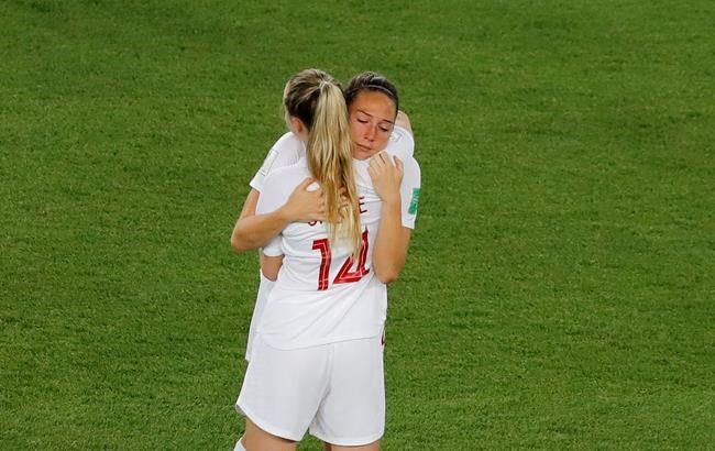 Canada's Gabrielle Carle and Lindsay Agnew, right, hug each other at the end of the Women's World Cup round of 16 soccer match between Sweden and Canada at the Parc des Princes in Paris, France, Monday, June 24, 2019. Canadian international Lindsay Agnew has been sidelined by a broken foot. THE CANADIAN PRESS/AP, Michel Euler