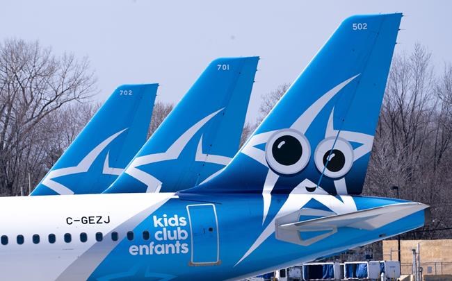 Air Transat aircrafts are seen on the tarmac at Montreal-Trudeau International Airport in Montreal, on Wednesday, April 8, 2020. Transat AT Inc. says it is planning to resume flying starting July 30. THE CANADIAN PRESS/Paul Chiasson