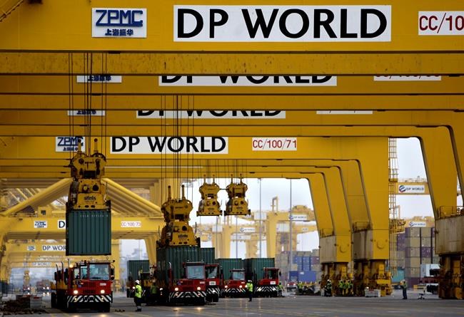 FILE - In this Feb. 8, 2009 file photo, cranes off load containers at the Jebel Ali port terminal 2, in Dubai, United Arab Emirates. One of the world's largest port operators, DP World, said Thursday, July 1, 2021, that it has acquired an American logistics firm in a $1.2 billion deal, the latest investment as the maritime company pushes to expand farther afield. (AP Photo/Kamran Jebreili, File)