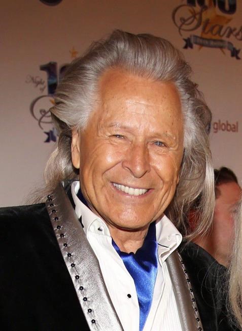 Peter Nygard arrives at the 24th Night of 100 Stars Oscars Viewing Gala at The Beverly Hills Hotel in Beverly Hills, Calif., on March 2, 2014. Toronto police say they will charge the former Canadian fashion mogul with multiple counts of sexual assault. THE CANADIAN PRESS/AP, Invision - Annie I. Bang