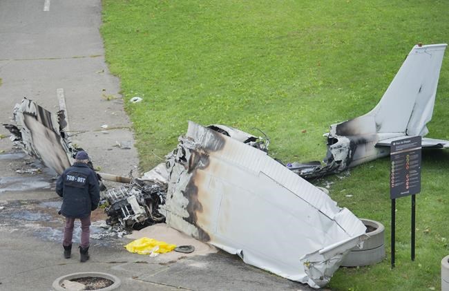 A member of the Transportation Safety Board (TSB) inspects the wreckage of a plane at a crash site in Montreal, Sunday, Oct. 3, 2021. The small plane crashed on île Sainte-Hélène, near Montreal’s Old Port on Saturday. THE CANADIAN PRESS/Graham Hughes