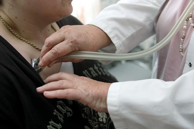 A doctor examines a patient with a stethoscope in her doctor's office in Stuttgart, Germany on April 28, 2008. THE CANADIAN PRESS/AP, Thomas Kienzle