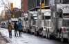 Trucks are parked on Metcalfe Street as a rally against COVID-19 restrictions in Ottawa, on Sunday, Jan. 30, 2022.&nbsp;Ontario Superior Court Justice Hugh McLean has granted a10-day injunction to prevent truckers parked on city streets in downtown Ottawafrom honking their horns incessantly. THE CANADIAN PRESS/Justin Tang