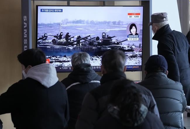 People watch a TV reporting the crisis in Ukraine during a news program at the Seoul Railway Station in Seoul, South Korea, Thursday, Feb. 24, 2022. Russian troops have launched their anticipated attack on Ukraine. President Vladimir Putin has cast aside international condemnation and sanctions, warning other countries that any attempt to interfere would lead to “consequences you have never seen.” (AP Photo/Ahn Young-joon)