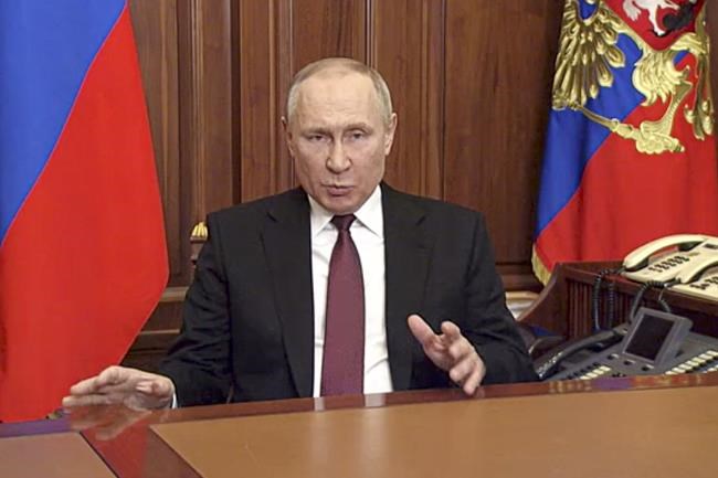 In this image made from video released by the Russian Presidential Press Service, Russian President Vladimir Putin addressees to the nation in Moscow, Russia, Thursday, Feb. 24, 2022. Russian troops launched their anticipated attack on Ukraine on Thursday, as Putin cast aside international condemnation and sanctions and warned other countries that any attempt to interfere would lead to