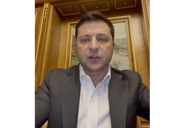 In this handout photo taken from video provided by the Ukrainian Presidential Press Office, Ukrainian President Volodymyr Zelenskyy addresses to the nation in Kyiv, Ukraine, Thursday, Feb. 24, 2022. Zelenskyy declared martial law, saying Russia has targeted Ukraine's military infrastructure. He urged Ukrainians to stay home and not to panic. (Ukrainian Presidential Press Office via AP)