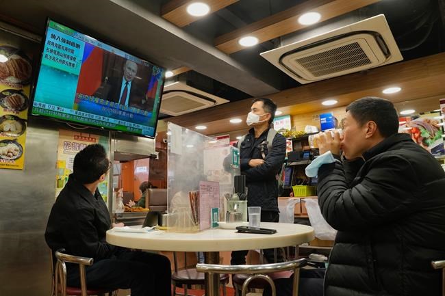 People watch a TV program broadcasting the news of Russian troops that have launched their attack on Ukraine, at a restaurant in Hong Kong Thursday, Feb. 24, 2022. Russian troops launched their anticipated attack on Ukraine on Thursday, as President Vladimir Putin cast aside international condemnation and sanctions, warning other countries that any attempt to interfere would lead to