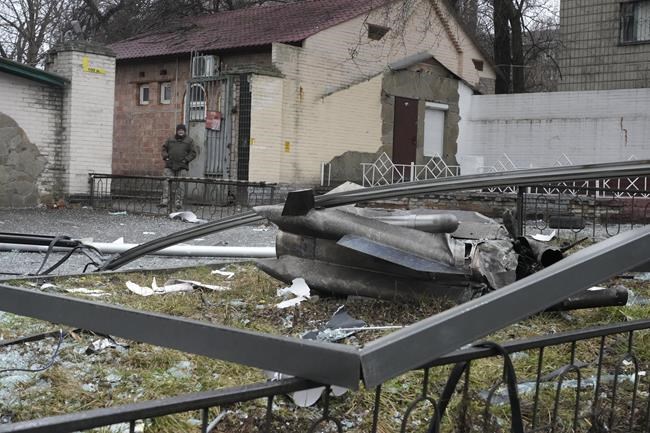 A man stands next to the consequences of Russian shelling in Kyiv, Ukraine, Thursday, Feb. 24, 2022. Russian troops have launched their anticipated attack on Ukraine. Big explosions were heard before dawn in Kyiv, Kharkiv and Odesa as world leaders decried the start of an Russian invasion that could cause massive casualties and topple Ukraine's democratically elected government. (AP Photo/Efrem Lukatsky)