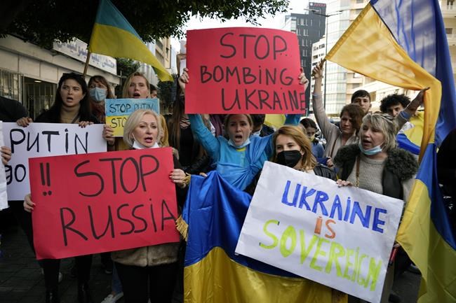 Ukrainians who live in Lebanon holds placards and chant slogans during a protest against Moscow's wide-ranging attack on their country, outside the Russian embassy in Beirut, Lebanon, Thursday, Feb. 24, 2022. World leaders expressed a raw outrage shrouded by an impotence to immediately come to the aid of Ukraine to avoid a major war in Europe, condemning Russia’s attack on its neighbor as the European Union and others promised unprecedented sanctions to hit the Kremlin. (AP Photo/Bilal Hussein)