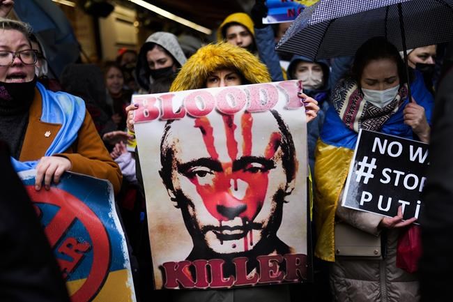 Pro-Ukraine people shout slogans during a small protest outside the Russian consulate in Istanbul, Turkey, Thursday, Feb. 24, 2022, after Russian troops launched an attack on Ukraine. (AP Photo/Francisco Seco)