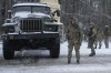 Ukrainian servicemen stand by a deactivated Russian military multiple rocket launcher on the outskirts of Kharkiv, Ukraine, Friday, Feb. 25, 2022. A spokesman for Global Affairs Canada said about 800 Canadians are currently living in Ukraine according to a registration service for Canadians abroad, but there might be more Canadians in the country as the registration in the service is voluntary. THE CANADIAN PRESS/AP-Vadim Ghirda