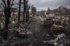 A Ukrainian serviceman walks amid destroyed Russian tanks in Bucha, on the outskirts of Kyiv, Ukraine, Wednesday, April 6, 2022. The RCMP is collecting evidence of alleged war crimes in Ukraine from people fleeing to Canada following Russia's invasion of their country. THE CANADIAN PRESS/AP-Felipe Dana