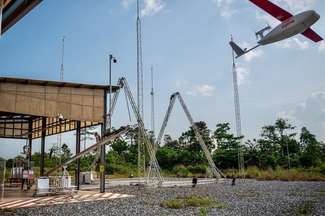 In this photo provided by Zipline, a drone flies to make a delivery at a Zipline hub in Vobsi, Ghana in 2021. Zipline, an American company that specializes in using autonomously flying drones to deliver medical supplies, has taken off in Japan. (Zipline via AP)