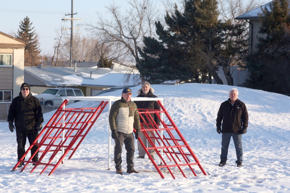 Tyler Clarke/The Brandon Sun
Kiwanis Club of Brandon members pose for a photo at Laurence and Louise Playground — a park they intend to refurbish this spring. From left is Darren Wright, Brian Manns, Hamid Mumin and Frank Thomas.