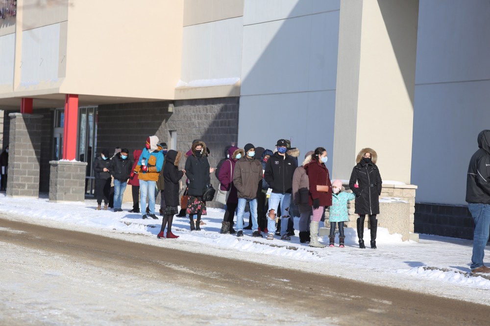 Drew May / The Brandon Sun
Shoppers wait in line to get into Winners at the Corral Centre on Saturday afternoon.