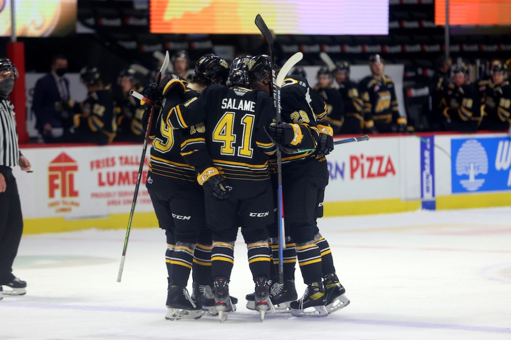 Keith Hershmiller Photography
Jake Chiasson (19) celebrates his goal against the Moose Jaw Warriors with Neithan Salame (41) and Nate Danielson (29) and two other teammates with the club’s signature helmet bump as players on the bench look on.