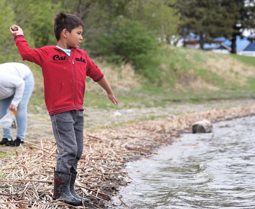 Tyler Clarke/The Brandon Sun
Kaistin Mecas, 6, throws a stone into Pelican Lake with authority, during a family camping trip in Ninette on Saturday. Elder sister Elizabeth Smoke said their family came from Dakota Plains to spend the weekend in two household clusters at neighbouring campsites. As per provincial health rules, they did not visit each other’s site, but were within speaking distance of one another.