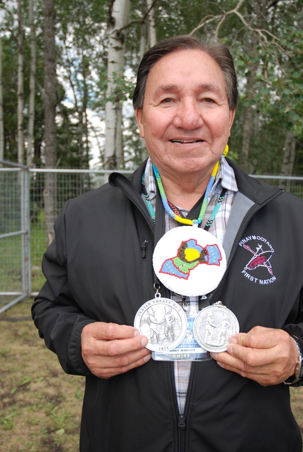 Chief Garnet Woodhouse of Pinaymootang First Nation shows his great-great grandfather, Richard Woodhouse's, medal he received 150 years ago at the signing of Treaty 2. Richard was one of the original signatories of Treaty 2. The larger medal, a replica of the original coin, is what Woodhouse received Saturday to commemorate the 150th anniversary of the signing of Treaty 2. (Kimberley Kielley/The Brandon Sun)