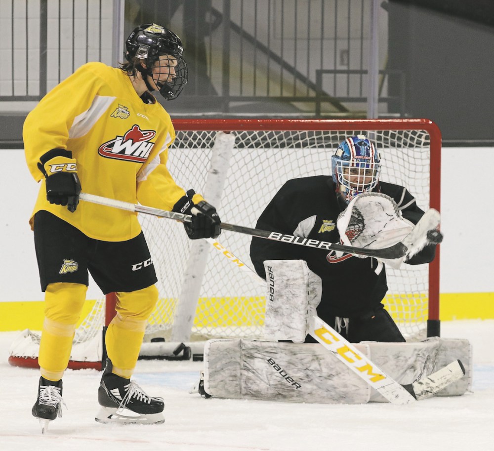 Perry Bergson/The Brandon Sun
Teydon Trembecky deflects a puck in front of goalie Nick Jones at Brandon Wheat Kings practice on Monday at Westoba Place. The team had only 15 players on the ice as they wait for nine guys to come back from pro camps.