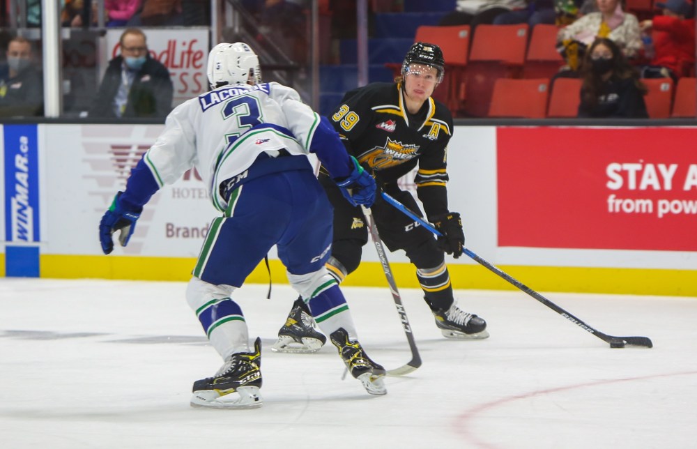 Chelsea Kemp/The Brandon Sun
Brandon Wheat Kings defenceman Chad Nychuk brings the puck in against the Swift Current Broncos defenceman Chase Lacombe in a Western Hockey League game Saturday at Westoba Place.
