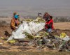 Rescuers work at the scene of an Ethiopian Airlines flight crash near Bishoftu, or Debre Zeit, south of Addis Ababa, Ethiopia, Monday, March 11, 2019. A spokesman says Ethiopian Airlines has grounded all its Boeing 737 Max 8 aircraft as a safety precaution, following the crash of one of its planes in which 157 people were killed. (AP Photo/Mulugeta Ayene)