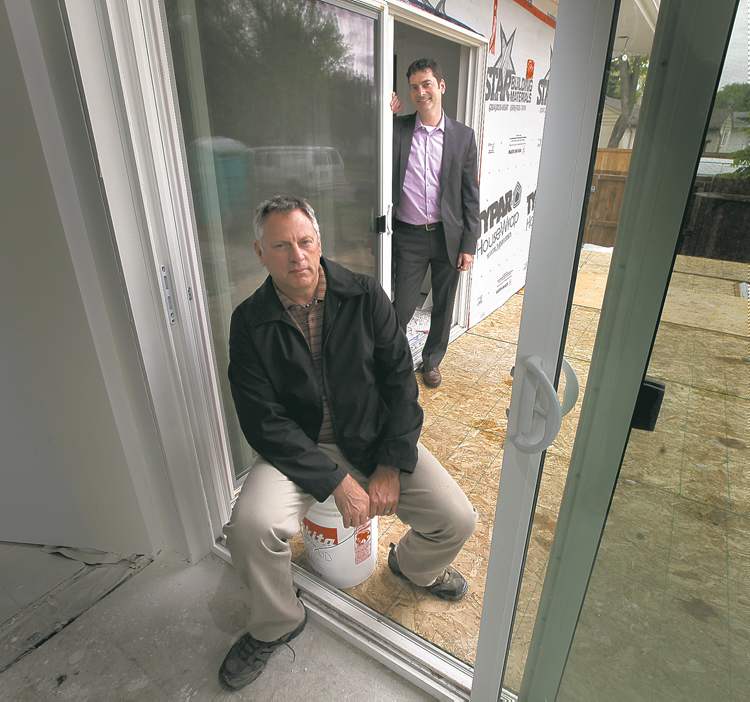 Phil Hossack / Winnipeg Free Press
Brad Sveinson (seated) of the Manitoba Home Builders' Association with Andrew Stibbard, whose home is being renovated.