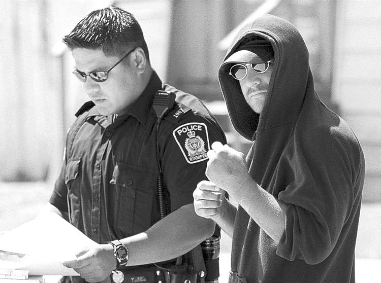 WINNIPEG FREE PRESS archives
Kevin Sylvester, seen here speaking to police after a 2001 attack on his house, would like to mentor at-risk youth.