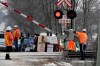 CN Railway workers check the railroad crossing gate as they prepare to resume service after Ontario Provincial Police made arrests at a rail blockade in Tyendinaga Mohawk Territory, near Belleville, Ont., on Monday Feb. 24, 2020, during a protest in solidarity with Wet'suwet'en Nation hereditary chiefs attempting to halt construction of a natural gas pipeline on their traditional territories. THE CANADIAN PRESS/Adrian Wyld