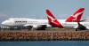 FILE - In this Aug. 20, 2015 file photo, two Qantas planes taxi on the runway at Sydney Airport in Sydney, Australia. Some Asian airlines have rerouted flights to the Middle East to avoid Iranian airspace, amid escalated tensions over the United States’ assassination of a prominent Iranian commander in Iraq. (AP Photo/Rick Rycroft, File)