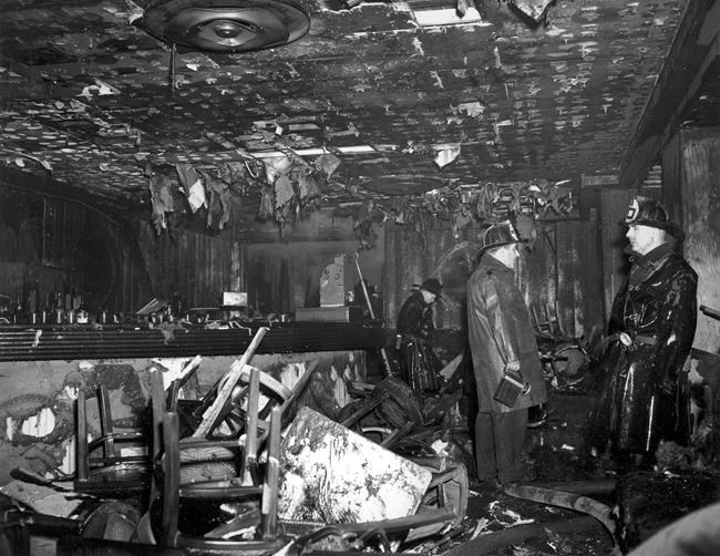 FILE - In this Nov. 28, 1942 file photo, firemen inspect the ruins of the Cocoanut Grove nightclub in Boston, where 492 people died in a fire. A 2019 documentary film,