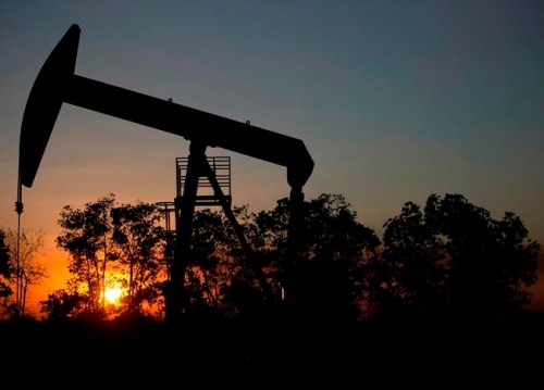 In this Feb. 19, 2015 file photo, the sun sets behind an oil well in a field near El Tigre, a town within Venezuela's Hugo Chavez oil belt, formally known as the Orinoco Belt. Analysts say U.S. sanctions against Venezuelan national oil company PDVSA will support higher prices for western Canadian heavy oil but it's unlikely to result in much of an increase in crude from Canada being shipped into the U.S. THE CANADIAN PRESS/AP/Fernando Llano, File