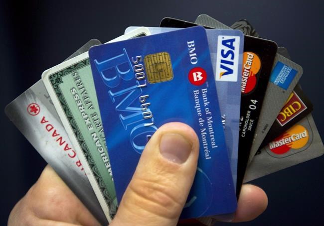 Credit cards are displayed in Montreal, Wednesday, December 12, 2012. Investment planning can often be seen as a luxury for the financially stable but advisers say that it's especially important for those who are starting out in their careers or are struggling with debt. THE CANADIAN PRESS/Ryan Remiorz