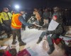 Police serve an injunction to protesters at a rail blockade in St-Lambert, south of Montreal on Thursday, February 20, 2020. As demonstrations continue across Canada in support of Wet'suwet'en hereditary chiefs opposing a pipeline through their territory, legal experts suggest it's time to reconsider how injunctions are employed when responding to Indigenous-led protests.THE CANADIAN PRESS/Ryan Remiorz