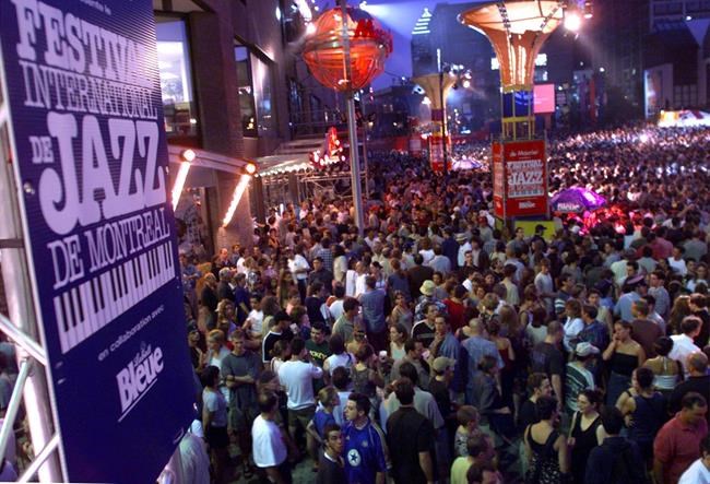 A huge crowd gathers for the annual giant mid-festival street show at the Montreal International Jazz Festival Tuesday in Montreal, July 6, 1999. This year's edition of the Montreal International Jazz Festival may have given concertgoers a glimpse of how they may have to enjoy musical performances for the next little while. THE CANADIAN PRESS/Paul Chiasson