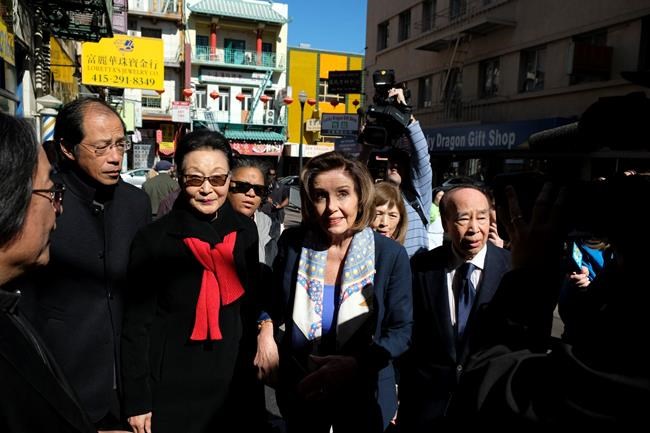 Speaker of the House Nancy Pelosi, D-Calif., walks with Florence Fang, second from left, to a temple during a tour of Chinatown Monday, Feb. 24, 2020, in San Francisco. Speaker Pelosi chatted with shop owners and took a walking tour of San Francisco's Chinatown in an effort to let people know the neighborhood is safe and would welcome their support. (AP Photo/Eric Risberg)