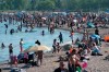 Scientists are warning that more young people are being infected with COVID-19, creating the potential for a severe outbreak. Thousands of people spend time on the beach by Lake Ontario in Toronto on Saturday June 20, 2020. THE CANADIAN PRESS/Frank Gunn
