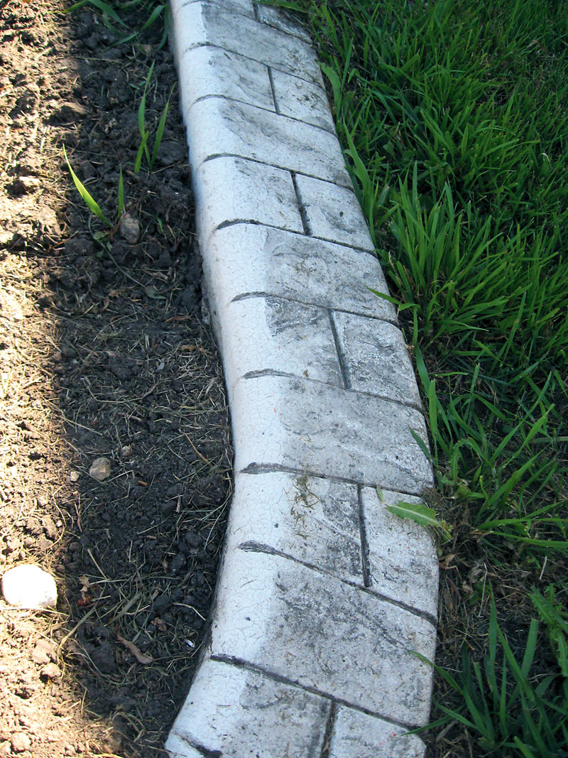 Albert Parsons/For the Sun
Concrete curbing products make attractive edges but grass will travel under the curbing and grass blades that grow over the curbing will have to be clipped to keep the line clean and crisp between turf and curb.