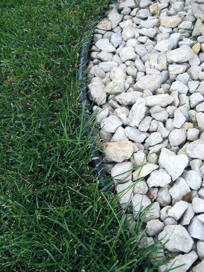 Albert Parsons/For the Sun
Plastic/vinyl edging products are used to prevent invasion by grass; here it separates crushed limestone mulch from the lawn.