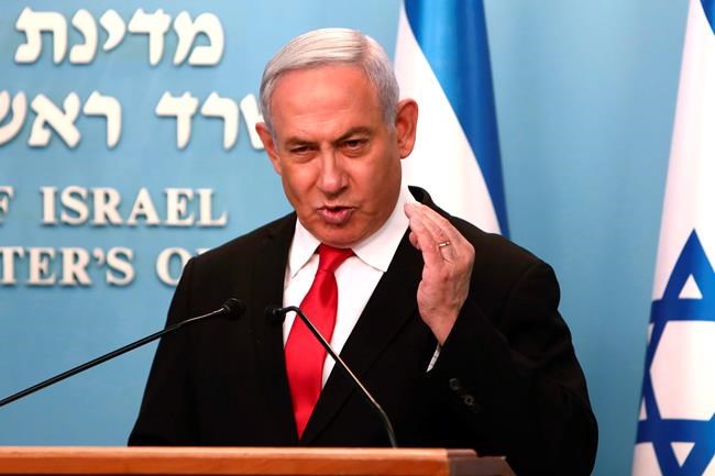 Prime Minister Benjamin Netanyahu delivers a speech from his Jerusalem office on Saturday, March 14, 2020, saying Israel's restaurants and places of entertainment will be closed to stop the spread of the coronavirus. He also encouraged people not to go to their workplaces unless absolutely necessary. (Gali Tibbon/Pool via AP)