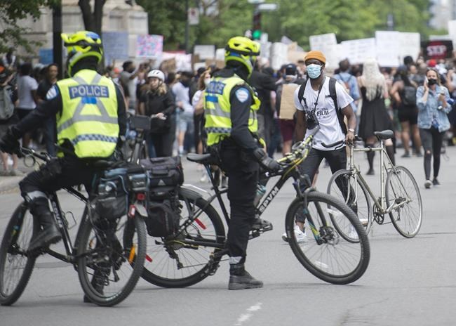 Police keep an eye protesters during a demonstration calling for justice for the death of George Floyd and all victims of police brutality, in Montreal on June 7, 2020. When someone broke into her car earlier this month, Meenakshi Mannoe considered calling police. The Vancouver resident weighed several questions: Would she get her belongings back? Was it even worth the hassle? And the tipping point: What good would it ultimately do? The weekend killing of Rodney Levi near Metepenagiag, N.B., -- the second Indigenous person to die at the hands of police in that province in less than a month -- has only intensified calls to defund the police as a part of a holistic approach to re-define public safety and how it's achieved. THE CANADIAN PRESS/Graham Hughes
