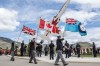 Flags are carried at a tribute ceremony to honour Capt. Jennifer Casey at the Kamloops Airport on May 21, 2020. A procession honouring the Canadian Forces Snowbirds aerobatic team member who was killed in recent a plane crash will make its way through the streets of Halifax this evening. THE CANADIAN PRESS/Jeff Bassett